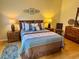 Comfortable bedroom featuring a queen-sized bed and dual nightstands at 2569 Errol Ter, The Villages, FL 32162