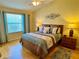 Bright main bedroom featuring a queen-sized bed and a ceiling fan at 2569 Errol Ter, The Villages, FL 32162