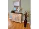 Dining area featuring a decorative console table, a large mirror, and a lush plant arrangement at 2569 Errol Ter, The Villages, FL 32162