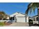 Charming home with a white picket fence, attached garage, and mature landscaping for curb appeal at 2569 Errol Ter, The Villages, FL 32162