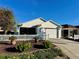 Charming single-story home with a well-manicured lawn, white picket fence, and attached garage at 2569 Errol Ter, The Villages, FL 32162