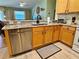 Kitchen area features a stainless dishwasher and updated countertops at 2569 Errol Ter, The Villages, FL 32162
