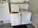 Bright laundry room equipped with a newer model top-load washing machine and a dryer at 2569 Errol Ter, The Villages, FL 32162