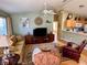Cozy living room with comfortable seating, modern decor, and a seamless view into the kitchen at 2569 Errol Ter, The Villages, FL 32162