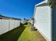 Manicured side yard featuring a white fence and healthy green grass for outdoor activities and enjoyment at 2569 Errol Ter, The Villages, FL 32162