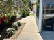The side yard showcases a clean walkway and lush, verdant landscaping at 2569 Errol Ter, The Villages, FL 32162