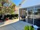 A sunroom features large windows, neutral patio furniture, and serene views at 2569 Errol Ter, The Villages, FL 32162