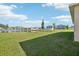 Spacious backyard with a serene pond view, lush green grass, and well-maintained lawn at 2916 Canary Ln, Tavares, FL 32778