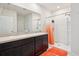 Well-lit bathroom with a double sink vanity, a shower and tub combination, and modern fixtures at 2916 Canary Ln, Tavares, FL 32778