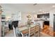 Open-concept dining area with a wooden table, opening up to the kitchen and living room at 2916 Canary Ln, Tavares, FL 32778