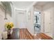 Inviting entryway with wood flooring, a stylish console table, and a glimpse into the bedroom at 2916 Canary Ln, Tavares, FL 32778