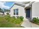 Close-up of a home's front entrance, showcasing the front door, landscaping, and architectural details at 2916 Canary Ln, Tavares, FL 32778