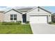 Charming single-story home with well-manicured lawn and attached two-car garage at 2916 Canary Ln, Tavares, FL 32778