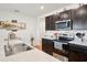 Kitchen showcasing dark cabinets, stainless steel appliances, and laminate countertops with a double sink at 2916 Canary Ln, Tavares, FL 32778