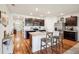 Open kitchen featuring dark cabinets, a central island with seating, and modern stainless steel appliances at 2916 Canary Ln, Tavares, FL 32778