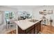Open kitchen with stainless steel sink, laminate countertops, and access to dining and living spaces at 2916 Canary Ln, Tavares, FL 32778