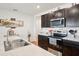 Bright kitchen with stainless steel appliances and dark wood cabinets at 2916 Canary Ln, Tavares, FL 32778