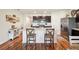 Well-lit kitchen featuring an island with bar seating, dark cabinets, and modern appliances at 2916 Canary Ln, Tavares, FL 32778