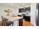 Well-equipped kitchen features a breakfast bar with dark cabinets and modern appliances at 2916 Canary Ln, Tavares, FL 32778