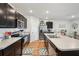 Spacious kitchen featuring dark wood cabinets, stainless steel appliances, and an island with a sink at 2916 Canary Ln, Tavares, FL 32778