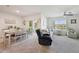 Bright and airy living room featuring neutral tones, comfortable seating, and a picturesque pond view at 2916 Canary Ln, Tavares, FL 32778