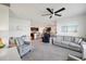 Open concept living room next to the kitchen, dining area, and filled with comfortable seating and neutral colors at 2916 Canary Ln, Tavares, FL 32778
