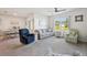 Bright living room with a view of the dining area and featuring a large window with a picturesque outdoor view at 2916 Canary Ln, Tavares, FL 32778
