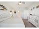 Comfortable main bedroom with neutral tones, carpet floor, and access to the bathroom at 2916 Canary Ln, Tavares, FL 32778