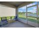 Relaxing screened-in patio with outdoor seating and a view of the backyard and pond at 2916 Canary Ln, Tavares, FL 32778