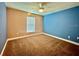Bedroom with neutral wall color, carpet, fan, and window at 30454 Island Club Dr, Deer Island, FL 32778