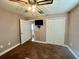 Bedroom includes fan, carpet, and closet with double doors at 30454 Island Club Dr, Deer Island, FL 32778