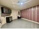 Garage with epoxy floor and wall mounted storage cabinets at 30454 Island Club Dr, Deer Island, FL 32778