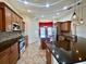 Spacious kitchen featuring dark countertops, stainless steel appliances, and wooden cabinetry at 30454 Island Club Dr, Deer Island, FL 32778