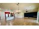 Open-concept living space with tile flooring, modern lighting, and kitchen featuring a breakfast bar at 30454 Island Club Dr, Deer Island, FL 32778