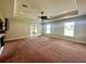 Spacious living room features a ceiling fan and neutral carpet at 30454 Island Club Dr, Deer Island, FL 32778