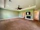 Large main bedroom with carpet flooring, ceiling fan, a fireplace and a walk-in closet at 30454 Island Club Dr, Deer Island, FL 32778