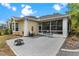 The cozy back patio offers a delightful outdoor space with a fountain, seating, and access to a screened-in porch at 6152 Topsail Rd, Lady Lake, FL 32159