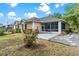 Expansive backyard featuring a stone patio, screened-in porch, and well-maintained lawn at 6152 Topsail Rd, Lady Lake, FL 32159