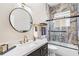 Modern bathroom boasting marble accents, a round mirror, and sleek fixtures for a luxurious feel at 6152 Topsail Rd, Lady Lake, FL 32159