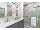 Modern bathroom with dual sinks, marble countertops, a walk-in glass shower, and elegant fixtures at 6152 Topsail Rd, Lady Lake, FL 32159