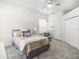 Spacious bedroom with plush carpeting, a ceiling fan, and a full closet with double doors for ample storage at 6152 Topsail Rd, Lady Lake, FL 32159