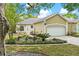 Charming home with lush landscaping and a well-maintained lawn at 6152 Topsail Rd, Lady Lake, FL 32159