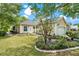 Beautiful home featuring a well manicured lawn, mature trees, and a two-car garage at 6152 Topsail Rd, Lady Lake, FL 32159