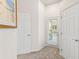 Hallway with white doors leading outside and to other rooms in the house at 6152 Topsail Rd, Lady Lake, FL 32159
