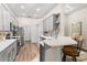 Bright open kitchen with stainless steel appliances, light countertops, and tile backsplash at 6152 Topsail Rd, Lady Lake, FL 32159