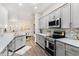 Bright open kitchen with stainless appliances, granite counters, and stylish backsplash at 6152 Topsail Rd, Lady Lake, FL 32159