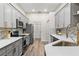Modern kitchen features stainless appliances, light countertops, and gray backsplash at 6152 Topsail Rd, Lady Lake, FL 32159