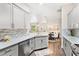 Bright kitchen with stainless steel appliances, grey cabinets, backsplash and an adjacent dining area at 6152 Topsail Rd, Lady Lake, FL 32159