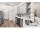 Modern kitchen features stainless appliances, light countertops, and stylish backsplash at 6152 Topsail Rd, Lady Lake, FL 32159