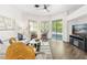 Bright living room with hardwood floors and a sliding glass door at 6152 Topsail Rd, Lady Lake, FL 32159